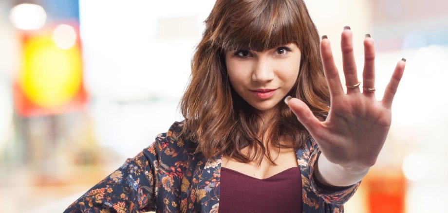 young woman doing stop sign