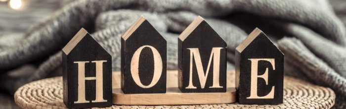 Cozy background with wooden letters with the inscription home.